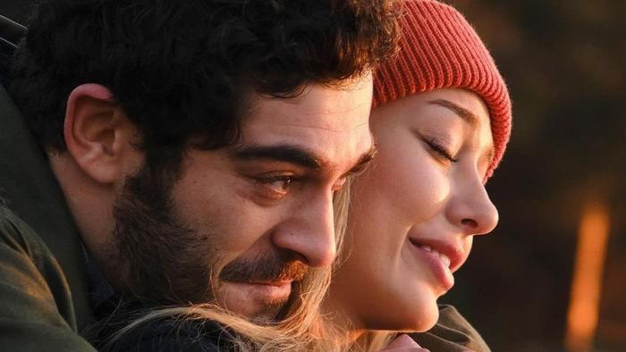Don't Leave movie: smiling white man on left hugs happy white woman on right with eyes closed