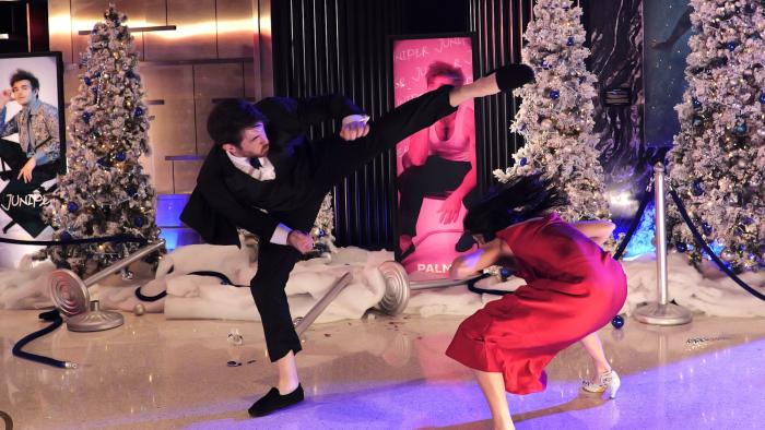 Double Trouble movie: Andrew Koji performs a martial arts kick while a villain ducks 
