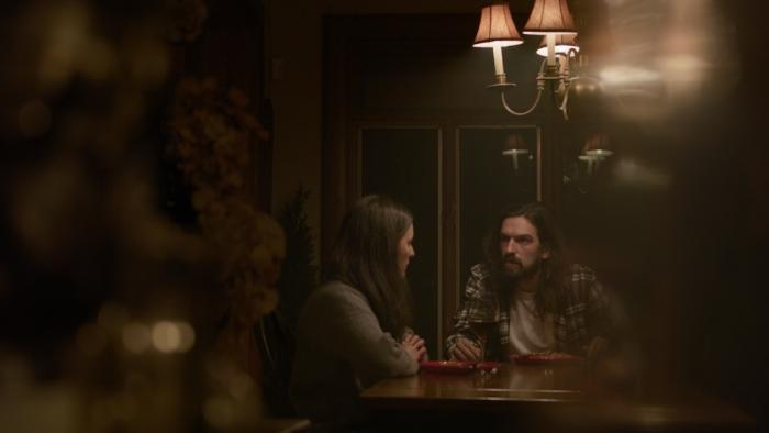 Dream Eater Movie: Mallory and Alex sit at a table, having what appears to be a serious talk
