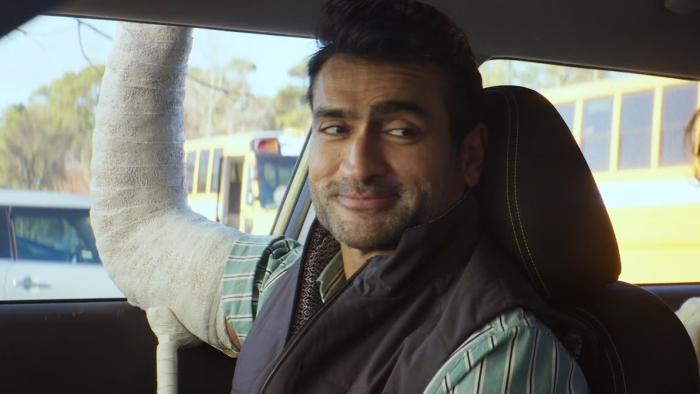 Driver's Ed movie: Kumail Nanjiani is in the passenger seat of a car, his arm in a cast