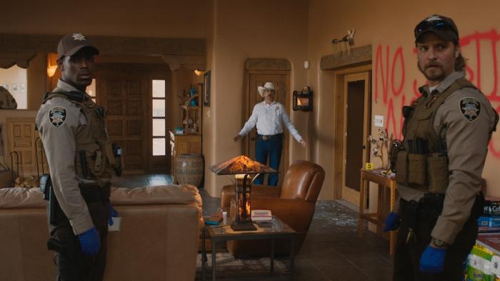 Eddington Movie: Joe Cross (center) and two officers (Micheal Ward, left, and Luke Grimes, right) investigate a crime scene