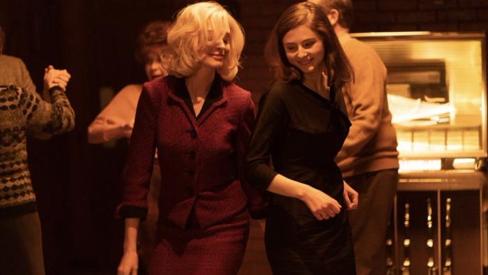 Eileen Movie: Anne Hathaway and Thomasin McKenzie dance at a bar