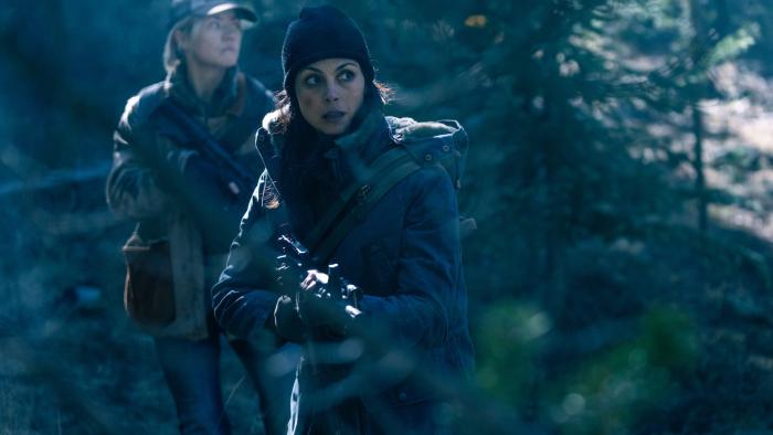 Elevation movie: Morena Baccarin and Maddie Hasson hold guns while walking cautiously through the woods