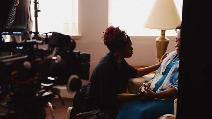 Emanuel Movie: Two women comfort each other in a suburban living room