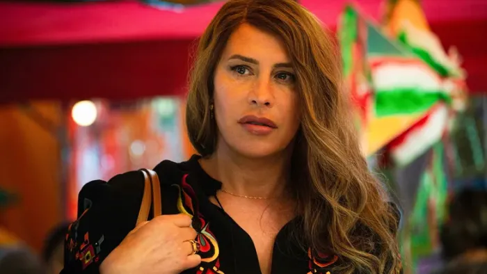Emilia Pérez: Karla Sofía Gascón in a colorful setting.