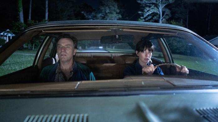 The End of Oak Street Movie: In the front seat of a car at night, Greg and Denise look around warily