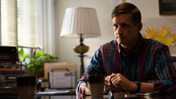 Eric LaRue movie: Paul Sparks sits at his desk