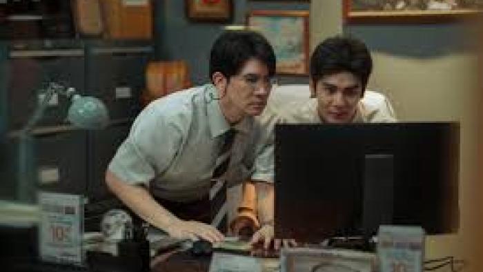 Everybody Loves Me When I'm Dead Movie: 2 Asian men look at a computer