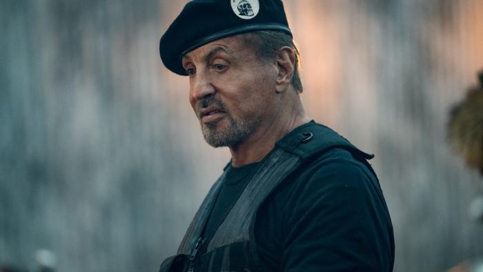 Expend4bles Movie: Barney Ross (Sylvester Stallone), wearing his Expendables cap and flak vest, poses alone