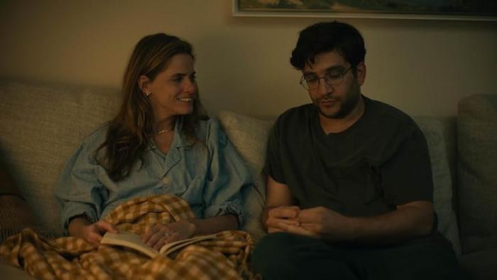 Fantasy Life movie: Amanda Peet turns and smiles at Matthew Shear while sitting on a couch
