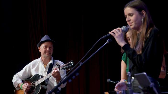 A Father's Promise Movie: Mark Barden (left) plays guitar and gazes lovingly at his daughter Natalie (right), who sings into a microphone