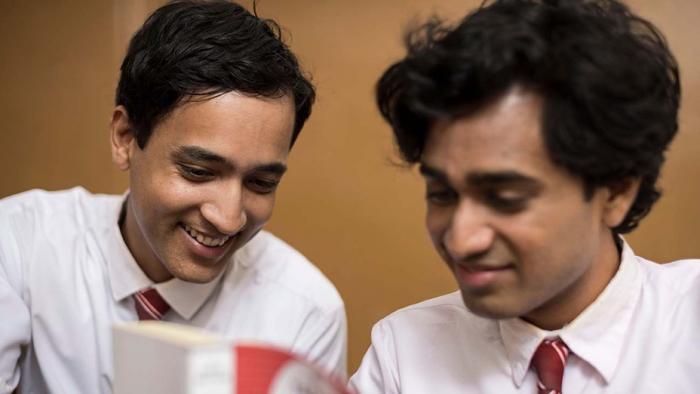 Funny Boy Movie: Two teens smile, wearing school uniforms