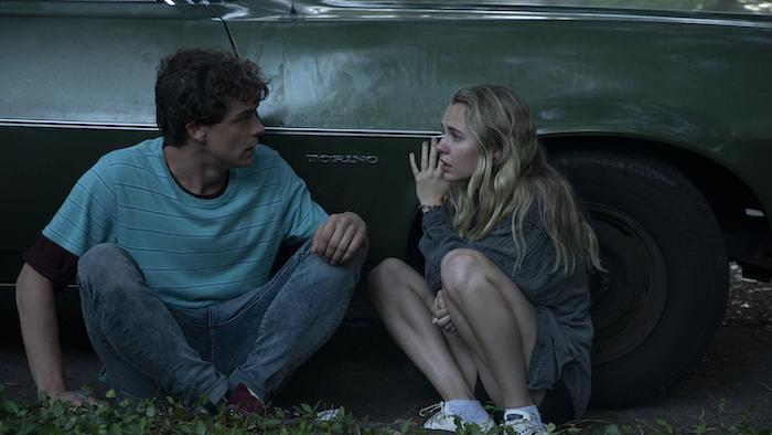 Fear of Rain Movie: Caleb and Rain hide behind a car