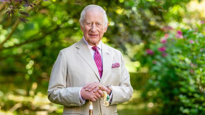 Finding Harmony—A King's Vision: King Charles III wears a light-colored suit and pink tie as he stands in a garden, surrounded by shrubbery