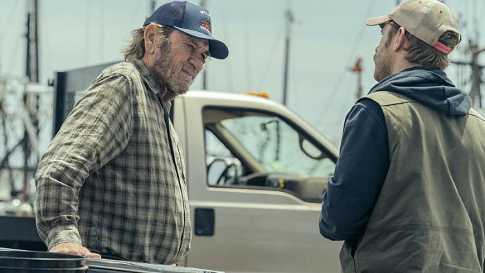 Finestkind Movie: Tommy Lee Jones, wearing a ball cap and a plaid shirt, leans against a car while speaking to his son (Ben Foster) at a marina