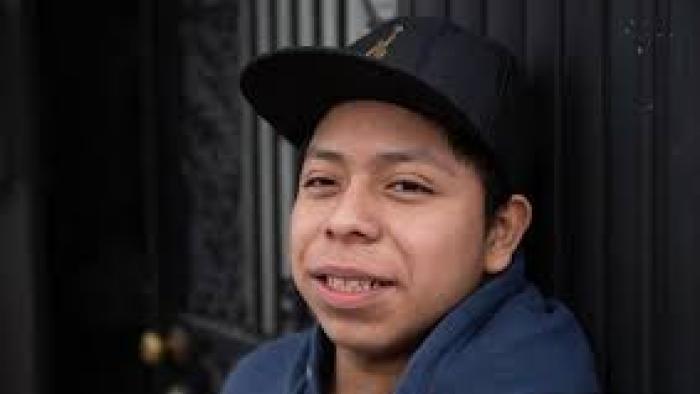 Five Years North Movie: Guatemalan boy wearing baseball hat