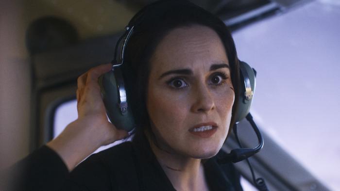 Flight Risk movie: Michelle Dockery looks stressed while wearing an aviation headset inside a plane