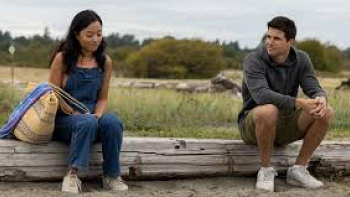Float Movie: Andrea Bang sits next to and speaks to Robbie Ammell outdoors