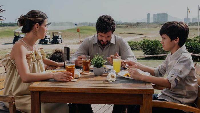 Flywheel: Ignition of the Soul movie: Mario Bregeira sits at the dinner table with Guilherme Tavares and Perola Faria