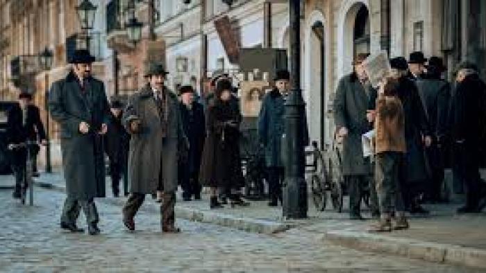 Forgotten Love: People walk on cobblestone street