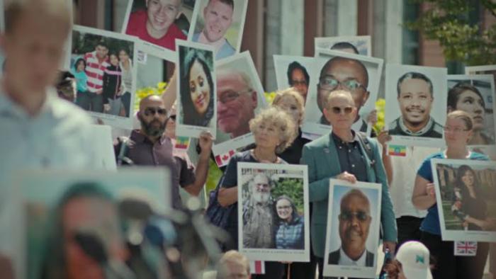 Freefall: A Reckoning for Boeing: People hold pictures of their lost loved ones.