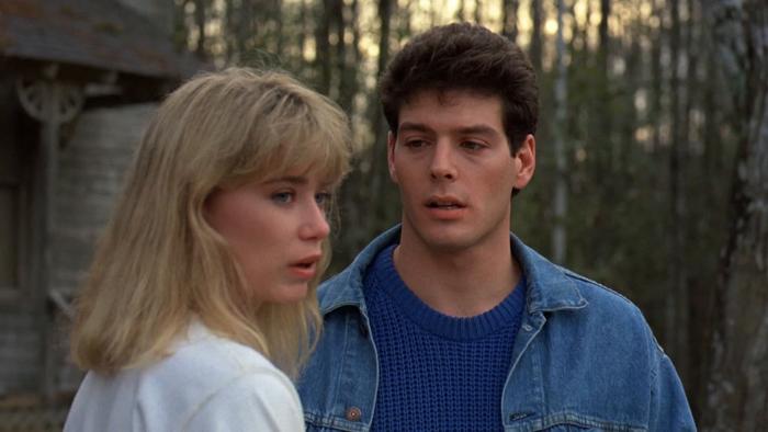 Friday the 13th Part VII -- The New Blood: A White teenage girl and a White teenage boy stand with woodland in the background, looking concerned