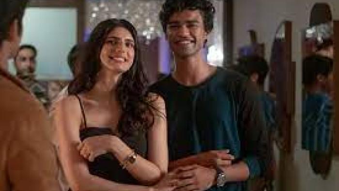 Friday Night Plan scene 1: a young Indian woman and man hold hands and smile: 