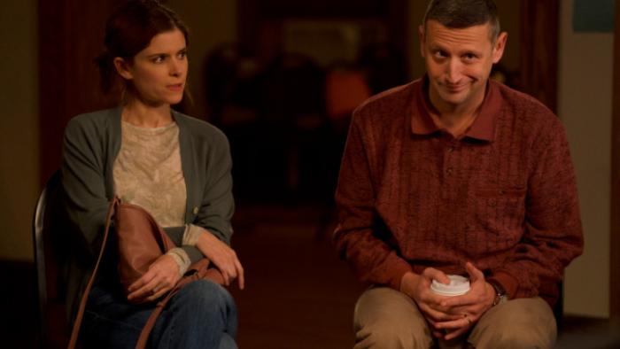 Friendship movie: Craig and Tami sit together on a couch in a suburban living room; Tami looks annoyed
