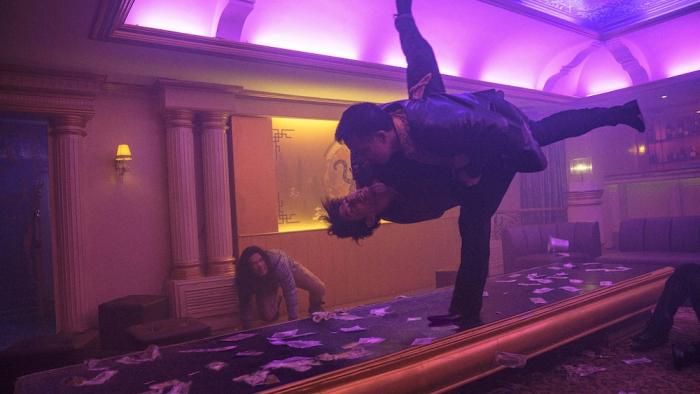The Furious Movie: In a nightclub illuminated by purple light, Navin (Joe Taslim) flips an opponent
