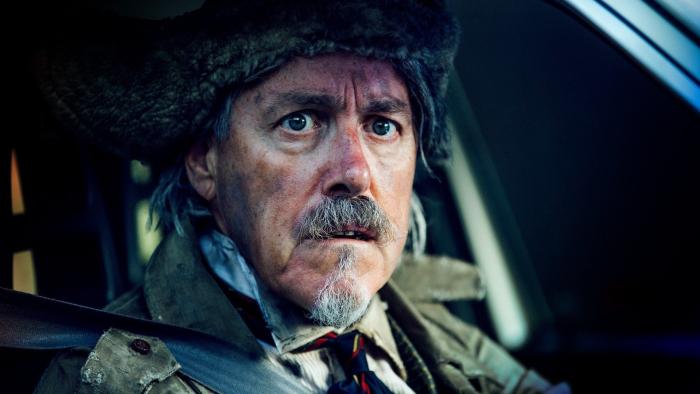 Future TX Movie: A disheveled Mr. Foley (Griff Rhys Jones) sits in a car, a look of great concern on his face