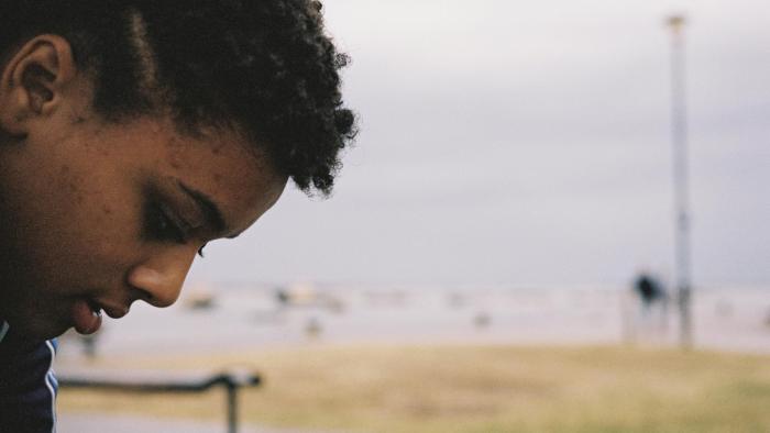 Bird: A young biracial girl looks at the ground