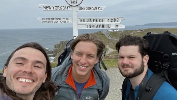 George Ezra -- End to End: George Ezra and two friends take selfie on coast with sign post behind them