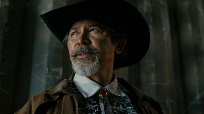 Get Fast movie: Lou Diamond Phillips looks on in black cowboy hat and brown jacket