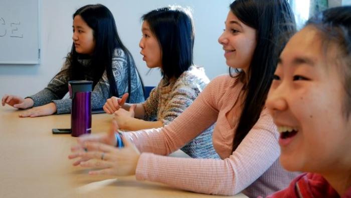 Girl Talk Movie:  girls sit and talk at a boardroom table