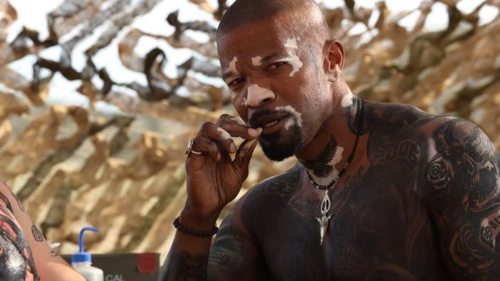 God Is a Bullet Movie: The Ferryman (Jamie Foxx), shirtless and covered in tattoos, smokes