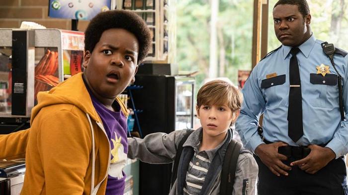 Good Boys Movie: Lucas and Max look shocked while a police officer scowls behind them