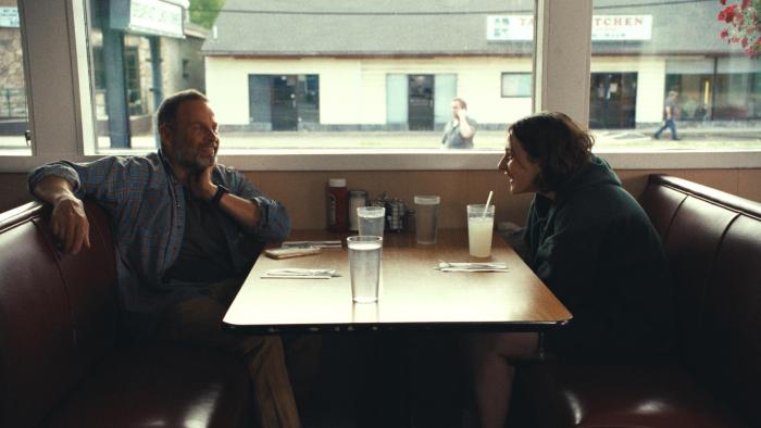 Good One Movie: Chris (James Le Gros) and daughter Sam (Lily Collias) laugh while waiting for their meal in a restaurant
