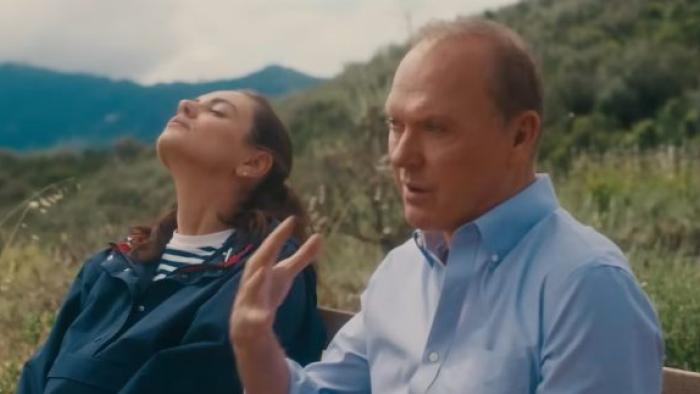 Goodrich Movie: Andy (Michael Keaton) and daughter Grace (Mila Kunis) chat on a park bench, Grace's face turned upward