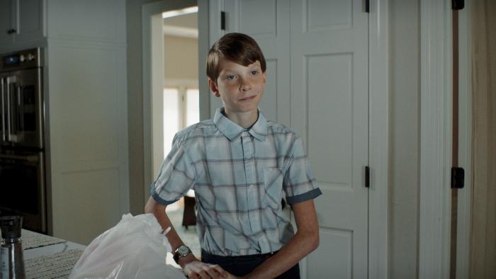 Griffin in Summer movie: Griffin (Everett Blunck) stands next to a couch, looking annoyed