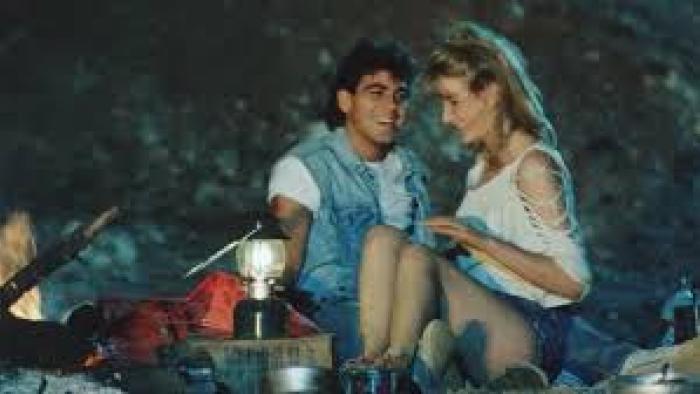 Grizzly II: George Clooney and woman snuggle together outside