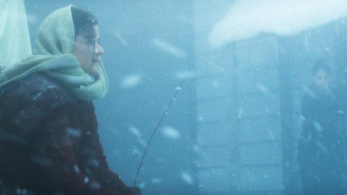 Hazel's Heart movie: Madelyn Dundon sits on top of a sled in a blizzard