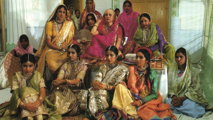 Heat and Dust: A group of women sit together wearing saris