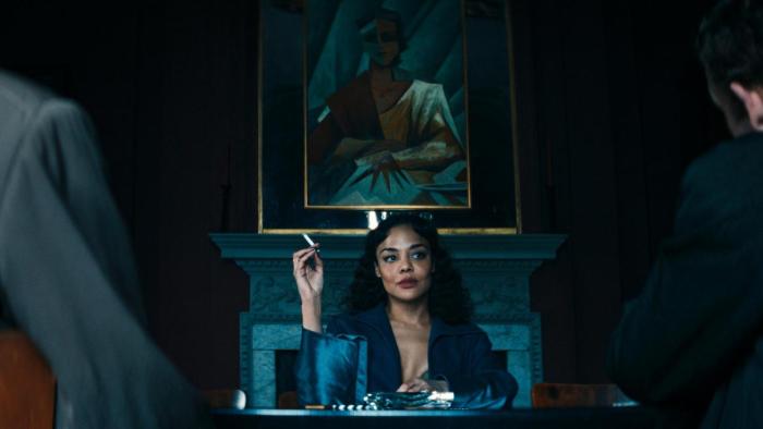 Hedda movie: Tessa Thompson speaks to other characters while holding a cigarette