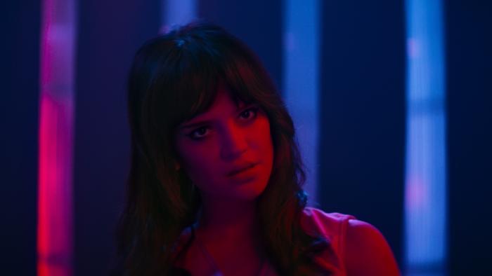Her Private Hell Movie: Elle, bathed in red light, appears perturbed about something