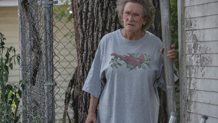 Hillbilly Elegy Movie: Mamaw stands by a rundown house wearing a gray T-shirt