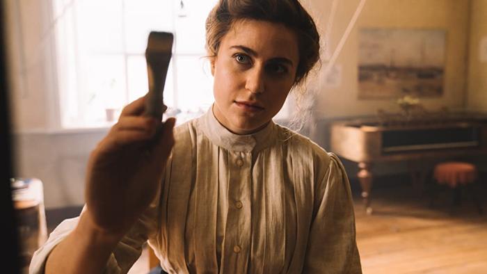 Hilma Movie: Tora Hallström holds up a paintbrush