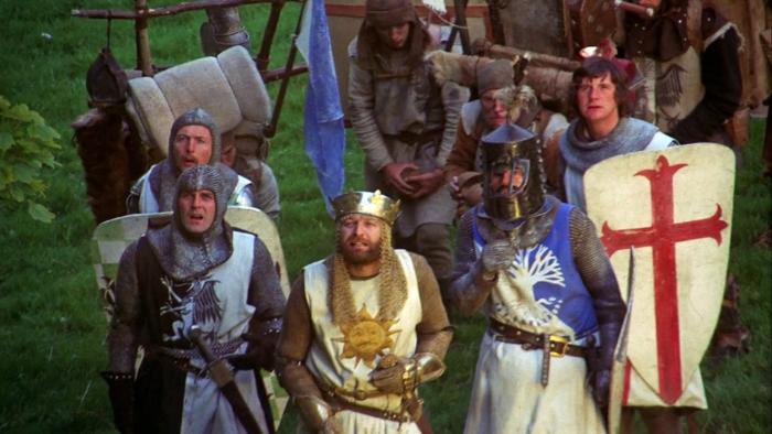 Monty Python and the Holy Grail Movie: White men in British medieval armor look up at the sky