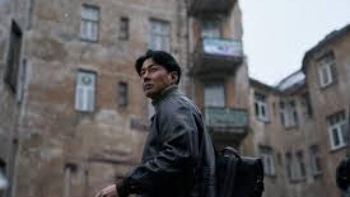 Humint Movie Poster: Korean man walks among old buildings