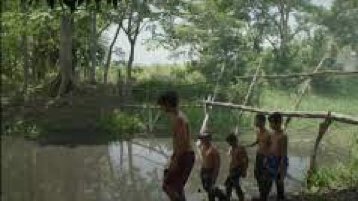 Hurricane Season scene 3:  Boys play by body of water