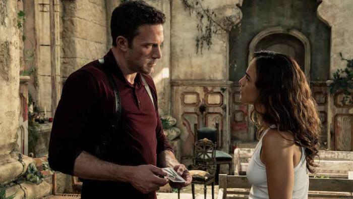 Hypnotic Movie: Danny Rourke speaks gravely with fortune-teller Diana Cruz in a Mexican courtyard